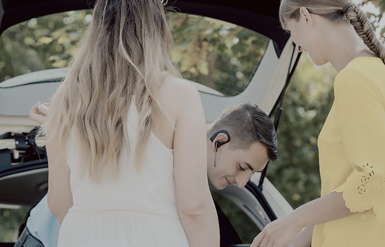 Taxi driver putting luggage of women in trunk of car Taxi driver putting luggage of women in trunk of car getting ready to start